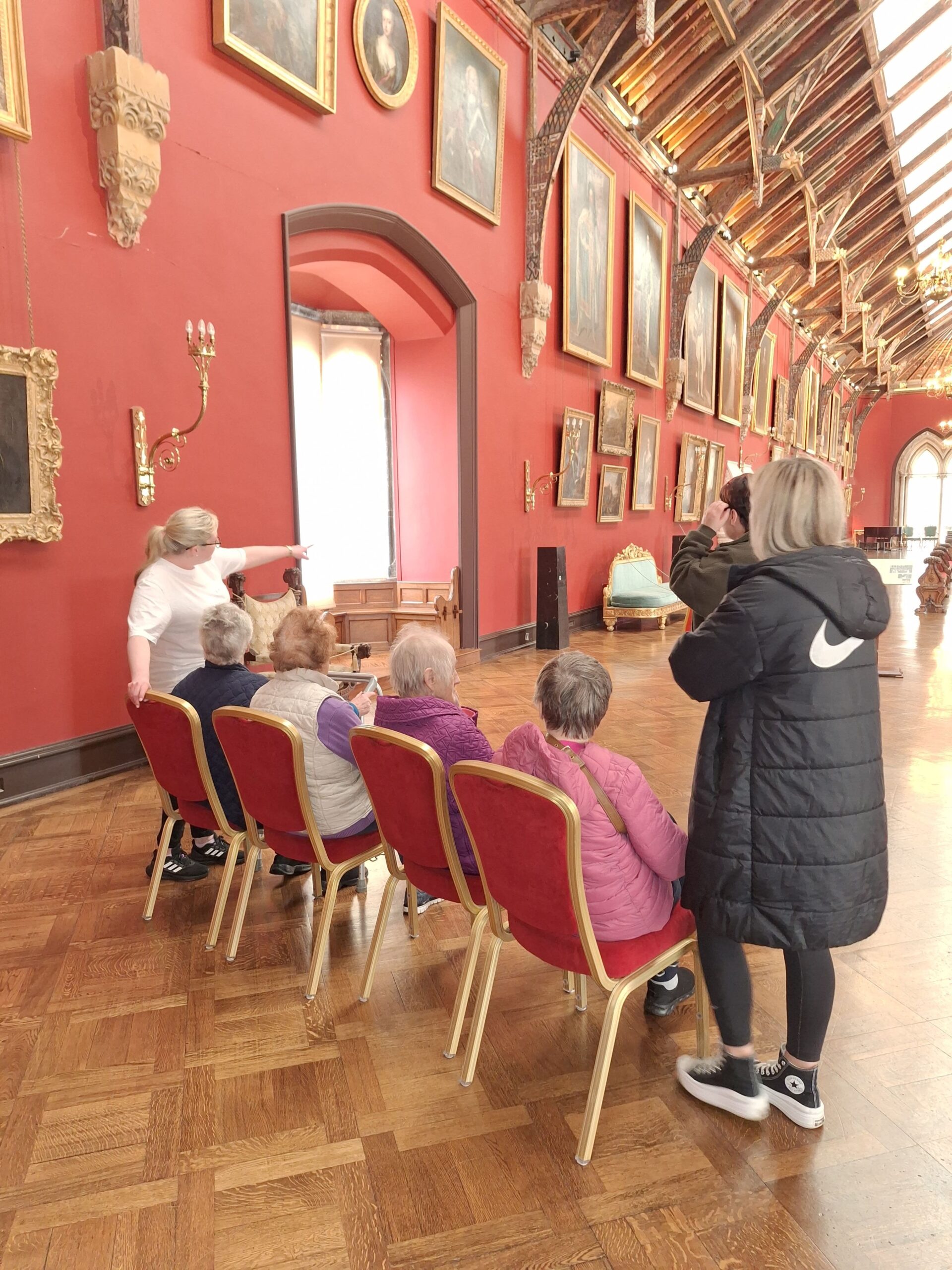 Trained guide giving a dementia inclusive tour of the Picture gallery to small group.